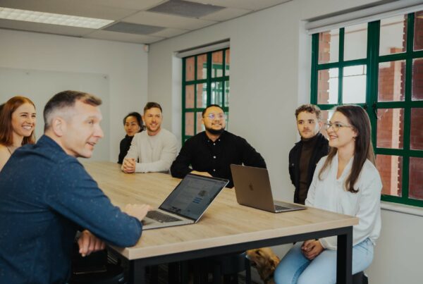 The Delta-v team hard at work, discussing sales.