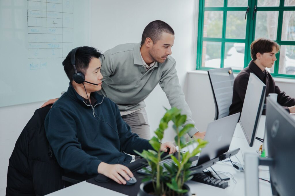 Two SDRs working at a computer, booking meetings for FinTechs and Enterprise Software companies